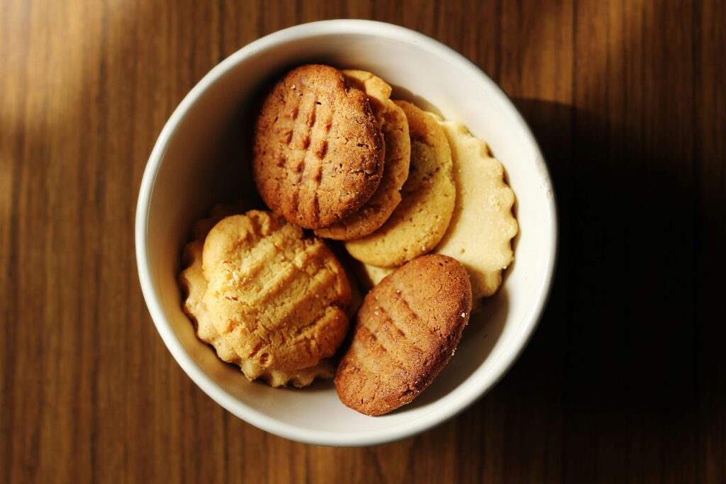 A close-up of homemade cookies in a white bowl, perfect for snacks or desserts.